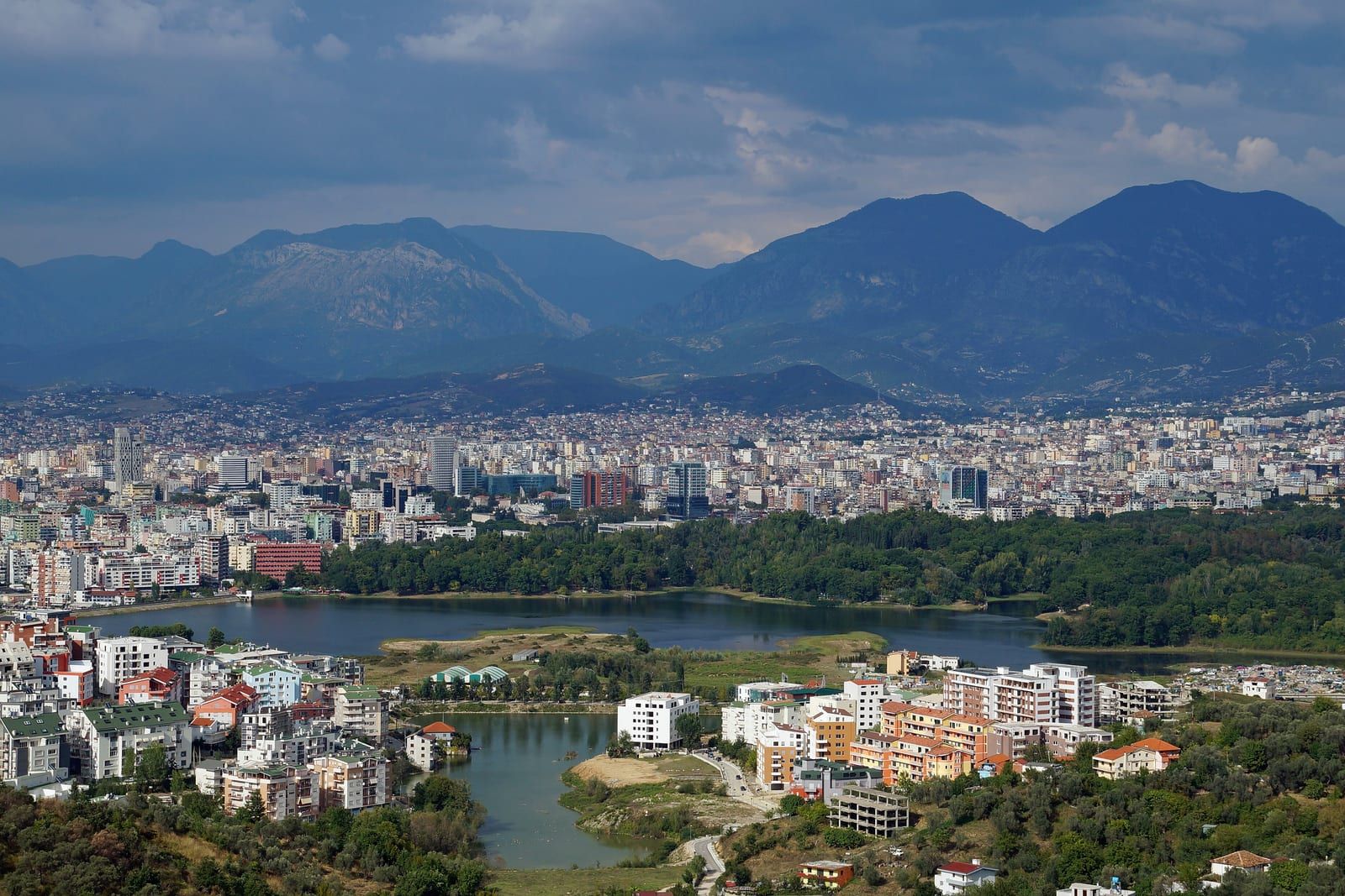 Tirana in its valley, the artificial lake in the foreground and the mountains beyond